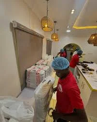 Kitchen staff packing food orders for delivery